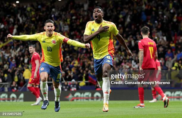 Jhon Cordoba of Colombia celebrates scoring his team's first goal alongside teammate James Rodriguez during the international friendly match between...