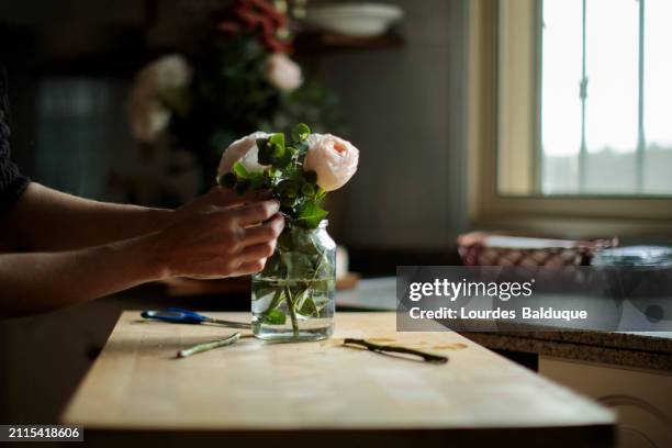 woman prepares bouquet of roses - florist arranging stock pictures, royalty-free photos & images