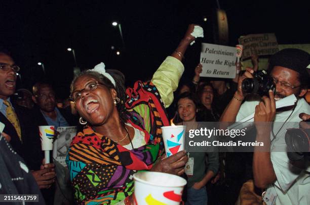 View of demonstrators as they participate in a candle-light vigil during at the World Conference Against Racism at the International Conference...