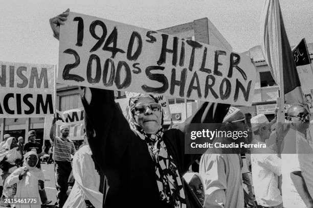 View of a demonstrator, holding a hand-written sign , as she participates in a march, organized by the African National Congress , during the World...