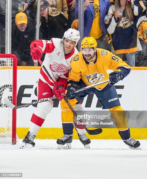 Ben Chiarot of the Detroit Red Wings defends against Filip Forsberg of the Nashville Predators during an NHL game at Bridgestone Arena on March 23,...