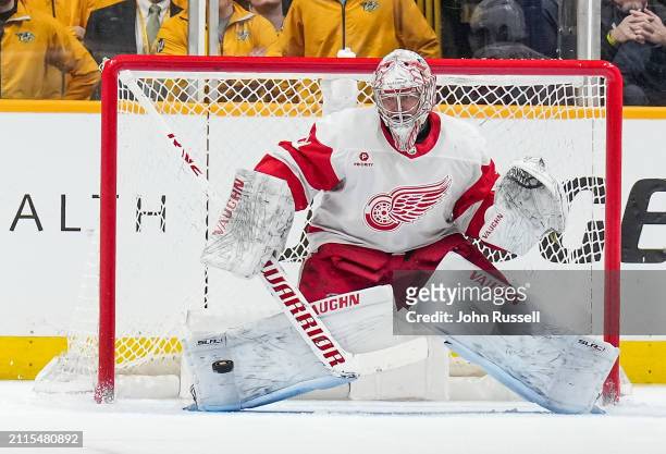 Alex Lyon of the Detroit Red Wings makes a save against the Nashville Predators during an NHL game at Bridgestone Arena on March 23, 2024 in...
