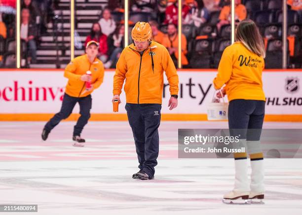 Nashville Predators Director of Ice Operations Nigel Schnarr checks the ice during intermission of an NHL game against the Detroit Red Wings at...