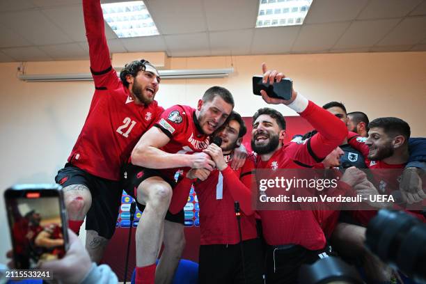 Giorgi Tsitaishvili, Giorgi Chakvetadze, Khvicha Kvaratskhelia and Zuriko Davitashvili of Georgia celebrate in the dressing room after the team's...