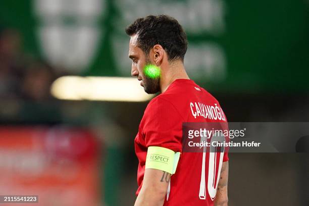 Laser is pointed at Hakan Calhanoglu of Turkey before taking a penalty-kick during the international friendly match between Austria and Turkiye at...