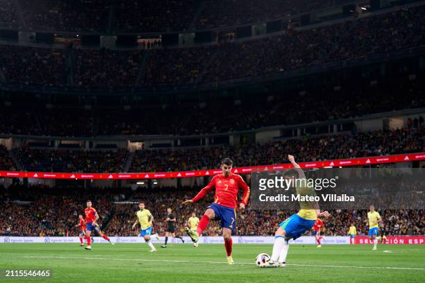 Lucas Beraldo of Brazil kicks the ball ahead of the pressure from Alvaro Morata of Spain during the friendly match between Spain and Brazil at...