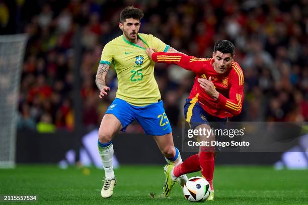 Alvaro Morata of Spain battles for the ball with Lucas Beraldo of Brazil during the friendly match between Spain and Brazil at Estadio Santiago...
