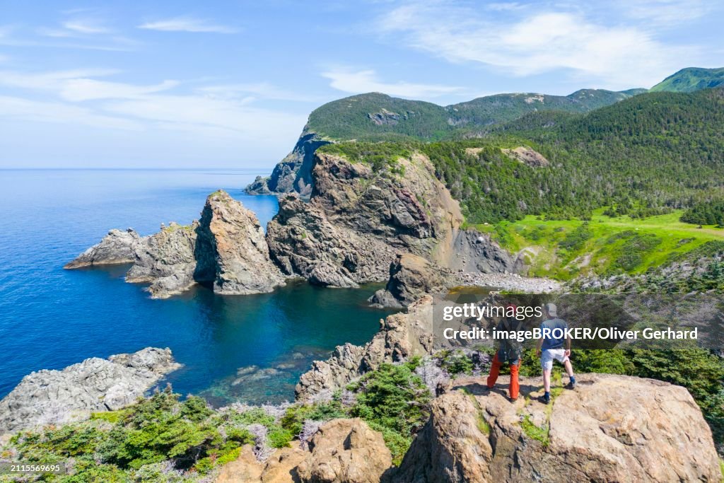 Aerial view, drone photo: Two men standing on a cliff above Bottle Cove, Bottle Cove Provincial Park, Bay of Islands, Newfoundland, Canada, North America