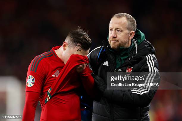 Connor Roberts of Wales leaves the field after suffering an injury during the UEFA EURO 2024 Play-Offs Final match between Wales and Poland at...