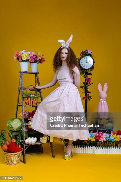 beautiful girl wearing pink dress - giant rabbit stock pictures, royalty-free photos & images
