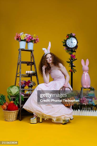 beautiful girl wearing pink dress - giant rabbit stock pictures, royalty-free photos & images