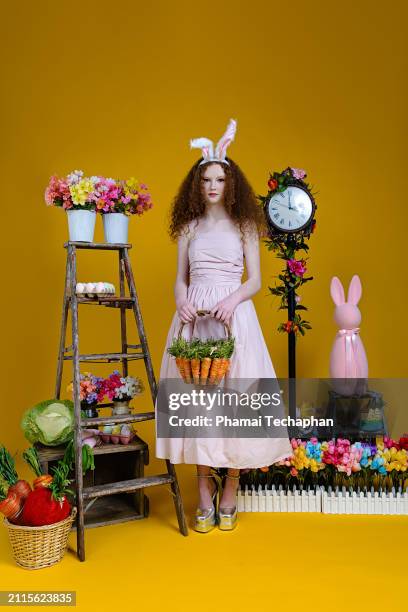 beautiful girl wearing pink dress - giant rabbit stock pictures, royalty-free photos & images