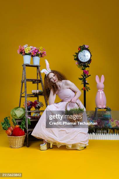 beautiful girl wearing pink dress - giant rabbit stock pictures, royalty-free photos & images