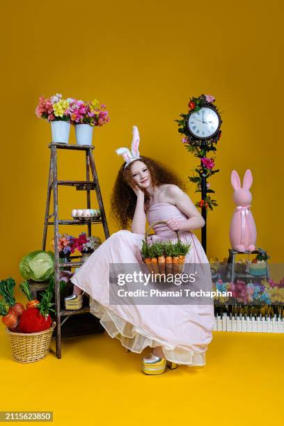 beautiful girl wearing pink dress - giant rabbit stock pictures, royalty-free photos & images