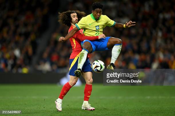 Endrick of Brazil is challenged by Marc Cucurella of Spain during the friendly match between Spain and Brazil at Estadio Santiago Bernabeu on March...