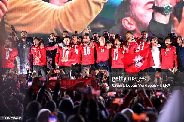 Players of Georgia celebrate qualification to the UEFA EURO 2024 with teammates on a stage after the UEFA EURO 2024 Play-Offs final match between...