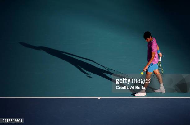 Carlos Alcaraz of Spain serves against Lorenzo Musetti of italy during their match on day 11 of the Miami Open at Hard Rock Stadium on March 26, 2024...