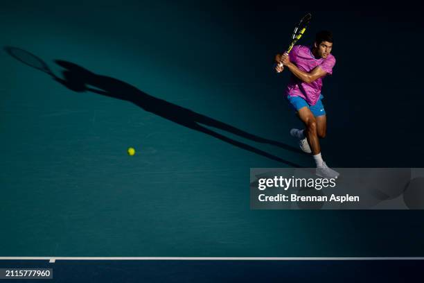 Carlos Alcaraz of Spain hits a shot against Lorenzo Musetti of Italy during their match during the Miami Open at Hard Rock Stadium on March 26, 2024...