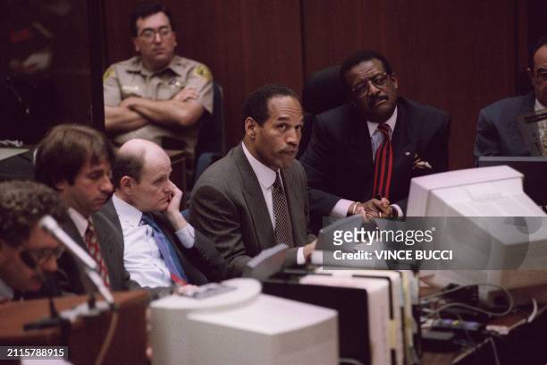 Double murder defendant O.J. Simpson looks at the overhead projection as Robin Cotton, director of Cellmark Diagnostics, explains genetic markers on...
