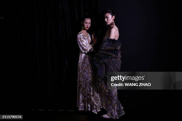 Models prepare backstage before the Cindy Wei Zhang Studio collection by Zhang Wei during China Fashion week in Beijing on March 29, 2024.