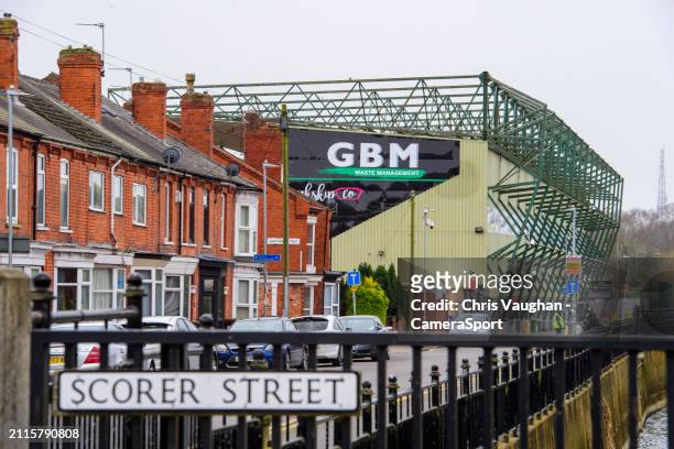 General view of LNER Stadium, home of Lincoln City, showing the outside of the GBM Stand with a street sign reading Scorer Street in the foreground...
