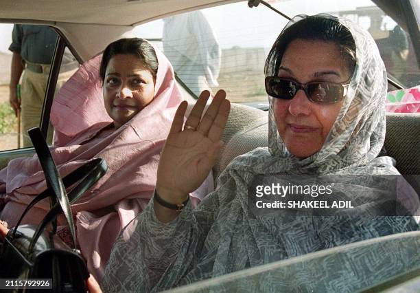 Kulsoom Nawaz , wife of deposed Pakistani prime minister Nawaz Sharif, waves to party supporters as she leaves court with Nusrat Shahbaz, wife of...