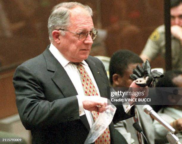 Defense Attorney F. Lee Bailey holds up a glove and plastic bag he wanted to use in his cross-examination of police detective Mark Fuhrman 15...