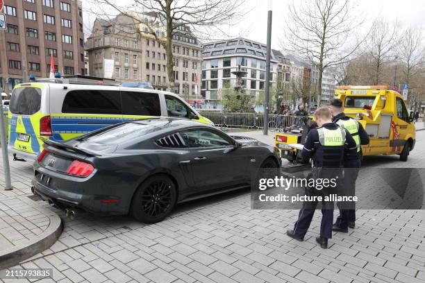 March 2024, North Rhine-Westphalia, Duesseldorf: Police officers stand next to a controlled car during a vehicle check. On Good Friday, the police...