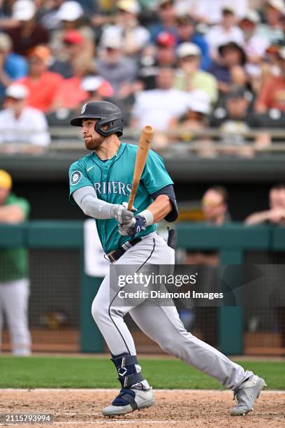 Tyler Locklear of the Seattle Mariners bats during the ninth inning of a spring training game against the Oakland Athletics at Hohokam Stadium on...