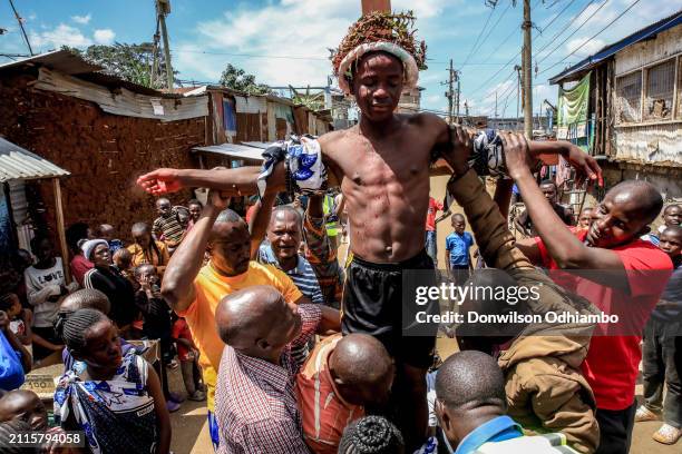 Boy is nailed to the cross during Good Friday procession in Kibera Slum on March 29, 2024 in Nairobi, Kenya.