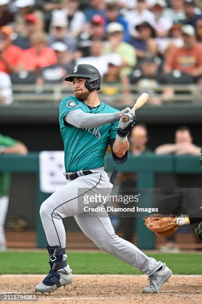 Tyler Locklear of the Seattle Mariners bats during the ninth inning of a spring training game against the Oakland Athletics at Hohokam Stadium on...