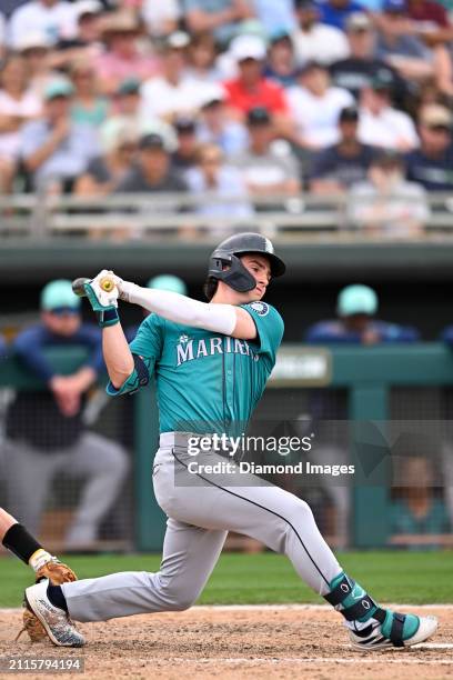 Cole Young of the Seattle Mariners bats during the eighth inning of a spring training game against the Oakland Athletics at Hohokam Stadium on March...