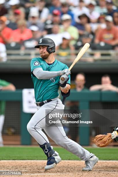 Tyler Locklear of the Seattle Mariners bats during the ninth inning of a spring training game against the Oakland Athletics at Hohokam Stadium on...