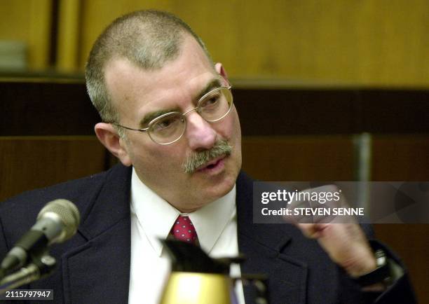 Dr. Ira Kanfer, a pathologist and witness for the defense, uses his fist while testifying during the trial of Thomas Junta 09 January 2002 at...