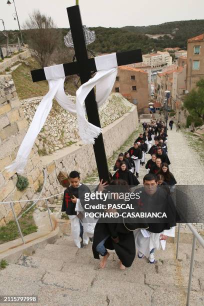 Sainte Croix Brotherhood climb the narrows streets during Holy Friday as part of Easter celebrations, in Bonifacio, on the French Mediterranean...