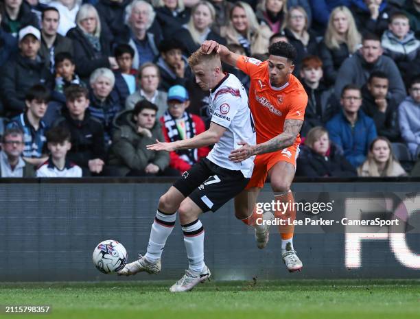 Blackpool's Jordan Lawrence-Gabriel evades a challenge from Derby County's Louie Sibley during the Sky Bet League One match between Derby County and...