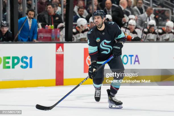 Justin Schultz of the Seattle Kraken skates along the blue line with the puck during the second period of a game against the Anaheim Ducks at Climate...