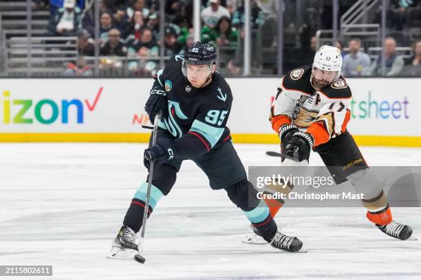 Andre Burakovsky of the Seattle Kraken skates with the puck at center ice during the third period of a game against the Anaheim Ducks at Climate...