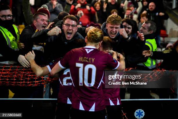 Northern Ireland , United Kingdom - 29 March 2024; Stephen Walsh of Galway United, hidden, celebrates with teammates David Hurley and Edward...