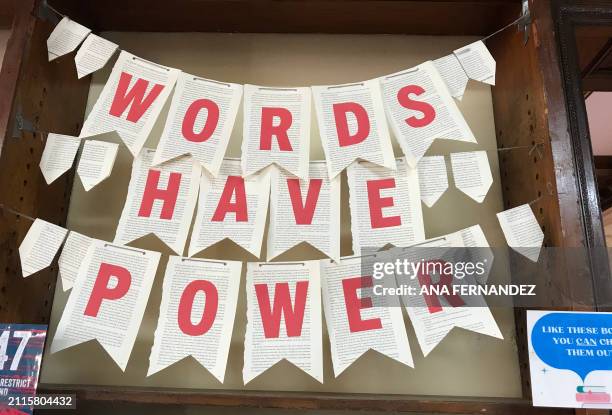 Handcrafted sign "Words Have Power" is seen over a display of banned books at the Hoboken Public Library in New Jersey on March 29, 2024. Faced with...