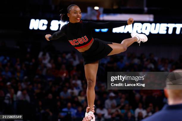 Cheerleader of the NC State Wolfpack performs during the first half against the Marquette Golden Eagles in the Sweet Sixteen round of the NCAA Men's...