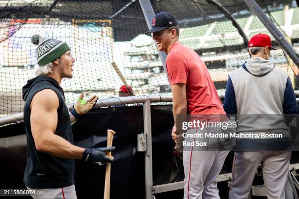 Jarren Duran of the Boston Red Sox reacts with Nick Pivetta of the Boston Red Sox during batting practice before a game against the Seattle Mariners...