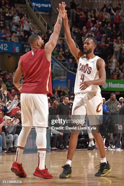 Evan Mobley of the Cleveland Cavaliers high fives Tristan Thompson during the game against the Philadelphia 76ers on March 29, 2024 at Rocket...