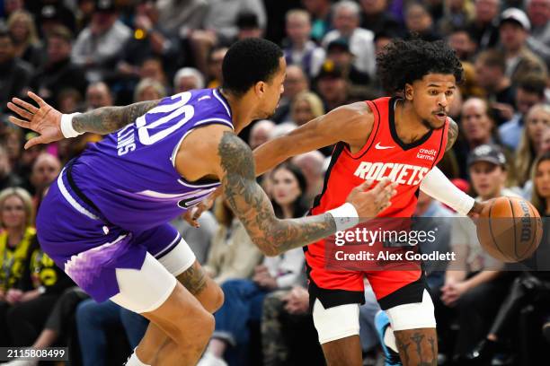 Jalen Green of the Houston Rockets drives past John Collins of the Utah Jazz during the first half of a game at Delta Center on March 29, 2024 in...