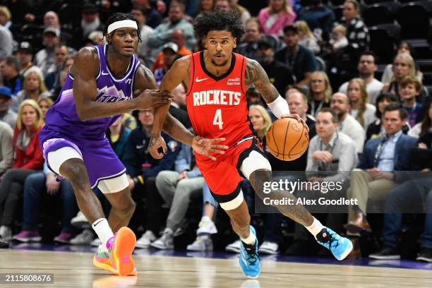 Jalen Green of the Houston Rockets drives past Taylor Hendricks of the Utah Jazz during the first half of a game at Delta Center on March 29, 2024 in...