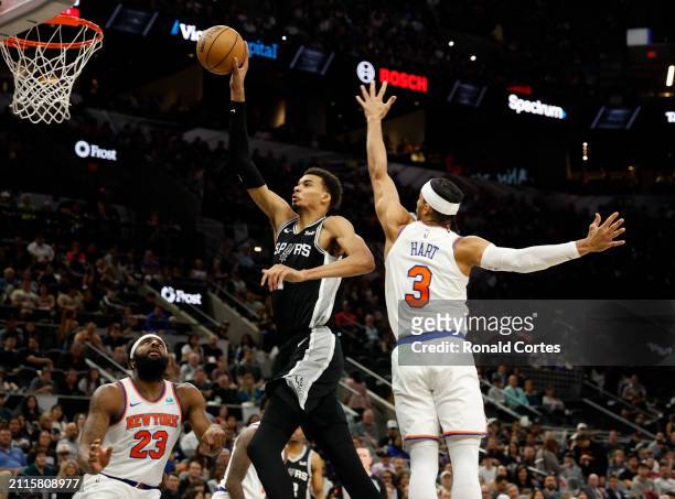 Victor Wembanyama of the San Antonio Spurs drives past Josh Hart of the New York Knicks in the first half at Frost Bank Center on March 29, 2024 in...