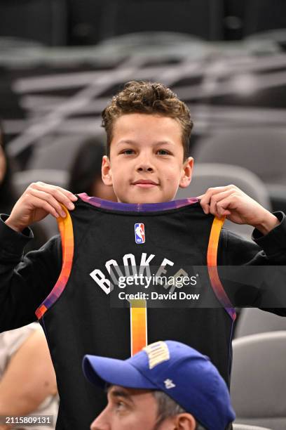 Phoenix Suns fan wears a Devin Booker jersey during the game against the San Antonio Spurs on March 25, 2024 at the AT&T Center in San Antonio,...