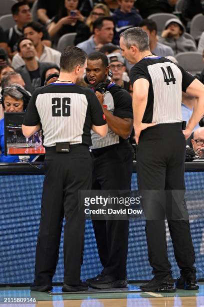 Referees Pat Fraher and Dedric Taylor watch a replay during the game between the Phoenix Suns and the San Antonio Spurs on March 25, 2024 at the AT&T...