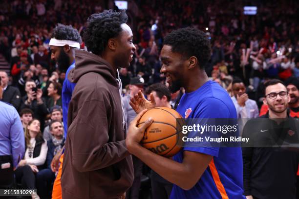 Shake Milton and OG Anunoby of the New York Knicks embrace during the game against the Toronto Raptors on March 27, 2024 at the Scotiabank Arena in...