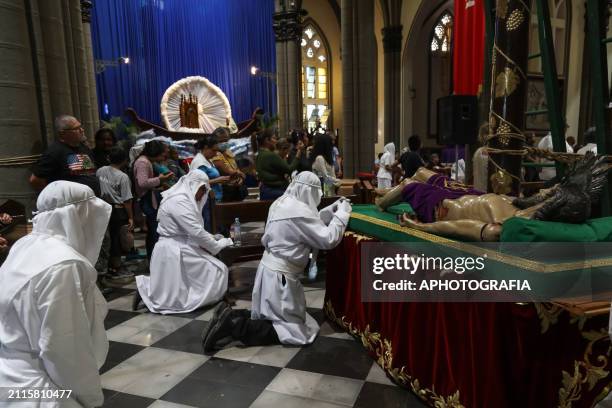 Catholic devotees pray before the image of Jesus Christ in the Holy Burial Procession in the "El Calvario" Church, in the historic center during the...